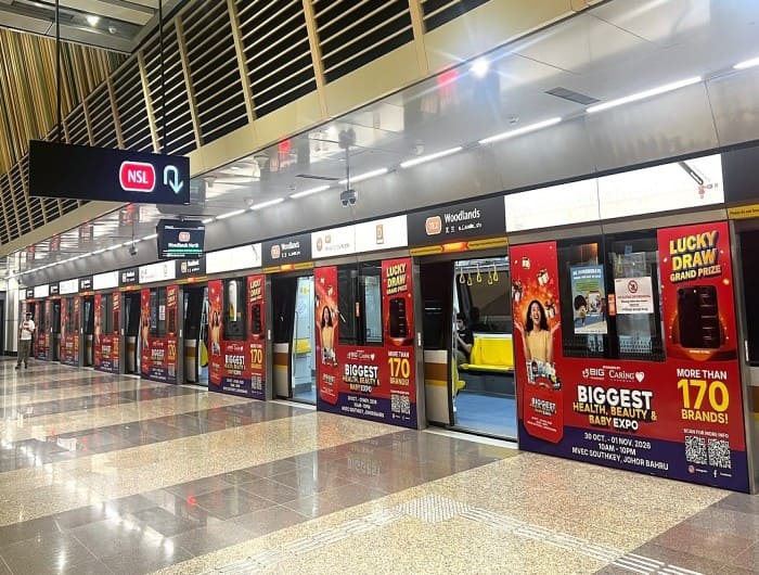 Big Caring Pharmacy platform station door ad at Woodlands MRT station, Singapore